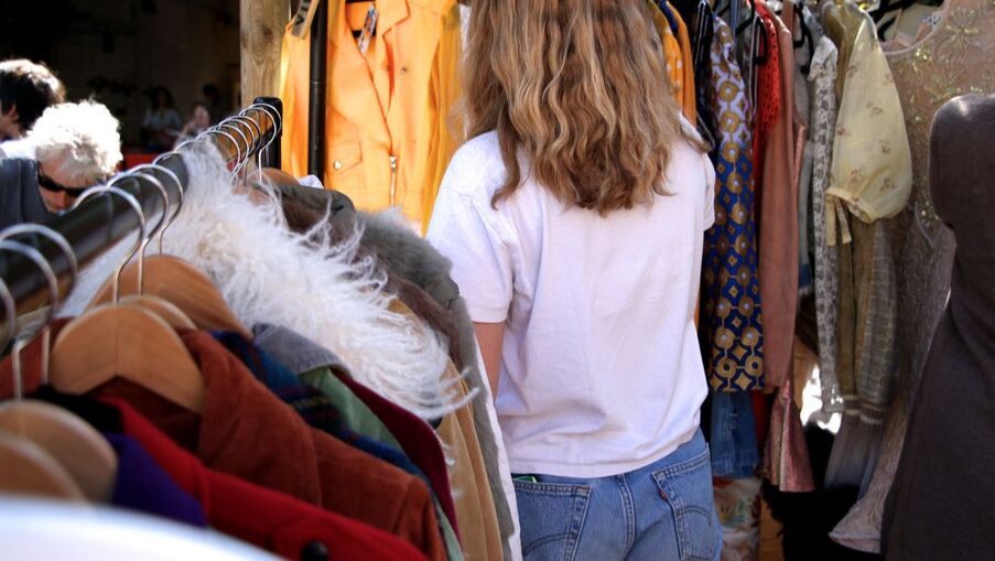 Customer browsing vintage clothing at Flea London